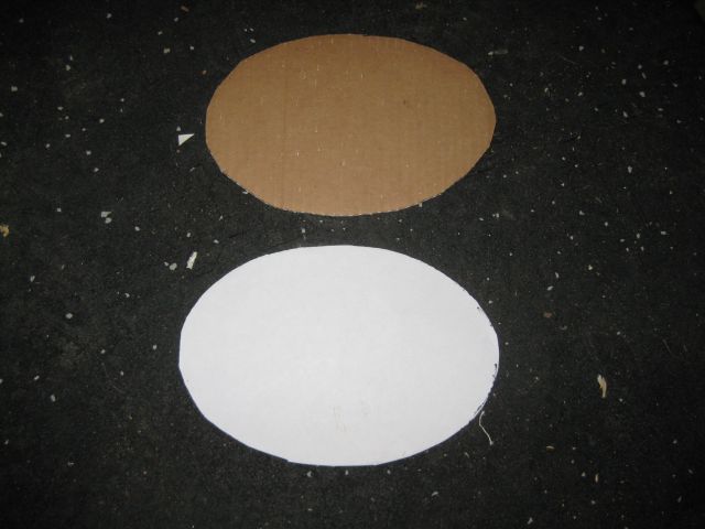 the printed elliptical shape on the white paper and the cardboard template to which it was transferred