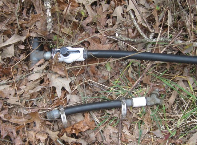 the 2 connections compared - above is the new connection with straight water flow valve connected to 3/4" black plastic pipe; and below is the traditional water faucet which connects to a hose